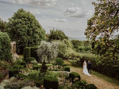 Couple walking through the knot garden