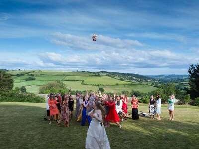 Guests on the lawn with the valley behind